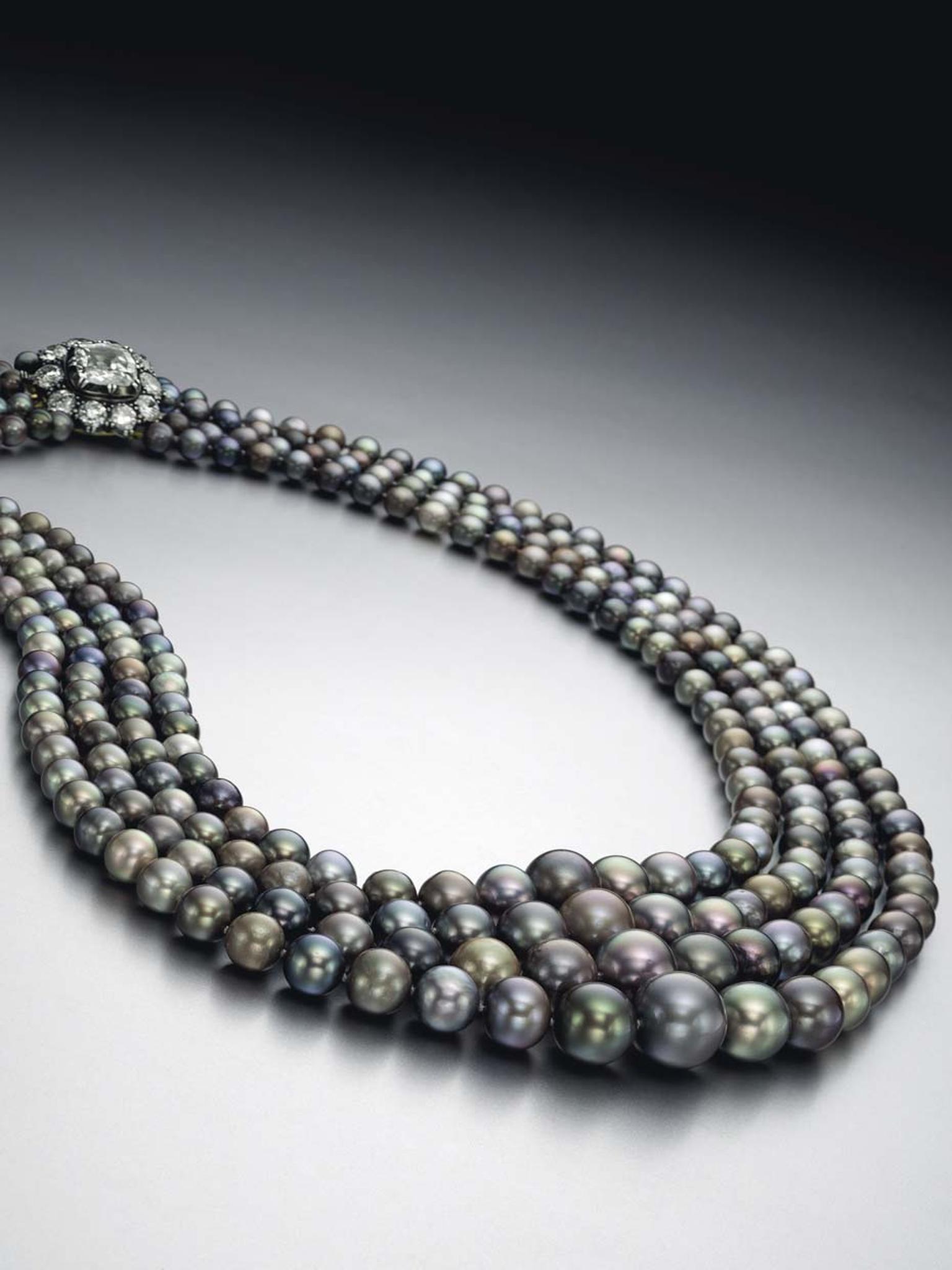 This fourstrand natural pearl necklace, set with colored